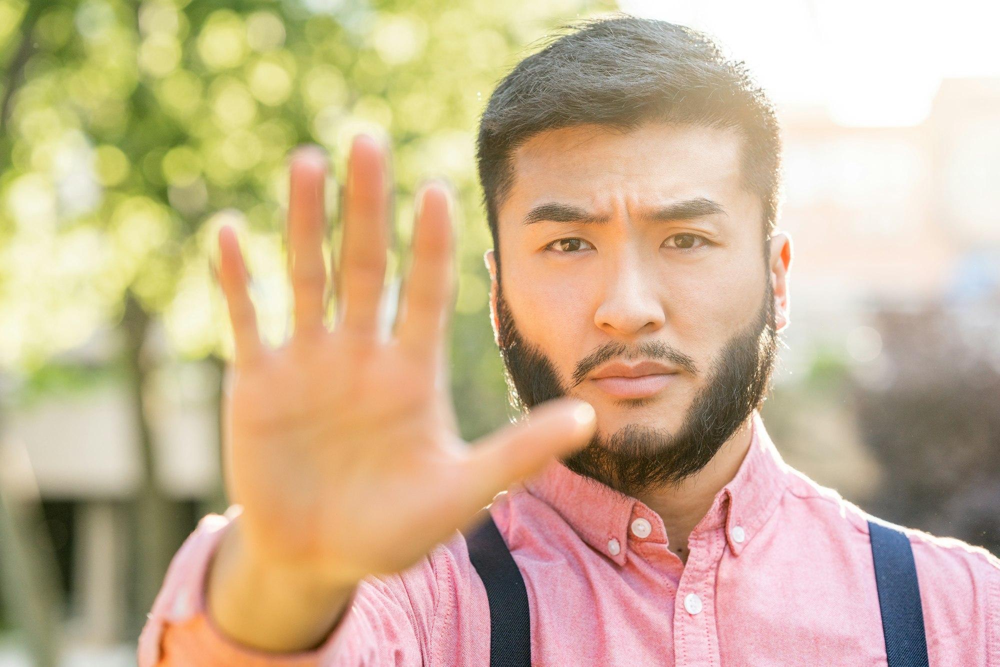 Asian man in casual clothes gesturing stop with the hand